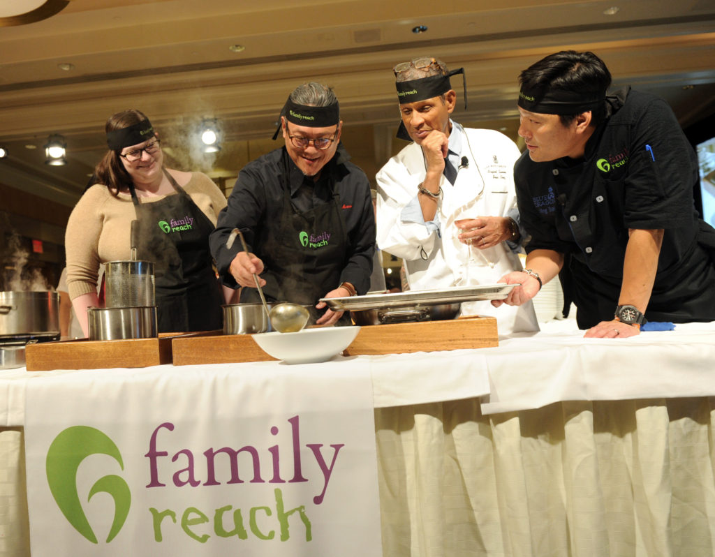 Iron Chef Morimoto, center left, and veteran broadcaster Bryant Gumbel, center right, with chef Ming Tsai, right, and guest Christine Rogers, left, prepare a dish at Family Reach's Cooking Live! charity event, Monday, Nov. 14, 2016 at The Ritz-Carlton New York, Battery Park.  The event raises funds to help families facing the daily cost of cancer.  (Photo by Diane Bondareff/Invision for Family Reach/AP Images)